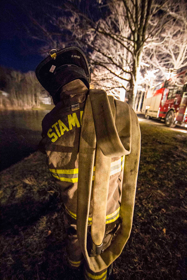 firefighter carrying hose